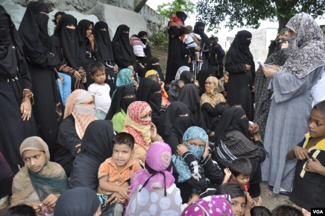 Some Rohingya women collecting charity from an NGO in Hyderabad. Most Rohingya refugees in India do menial jobs, to earn their livelihood. (Mir Imran/VOA)