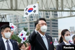 윤석열 한국 대통령이 15일 광복절 기념식에서 태극기를 흔들고 있다.