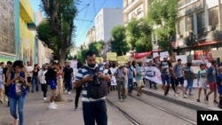 Tunisian reporters cover a demonstration in the capital Tunisa. (Lisa Bryant/VOA)