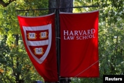 FILE - Banners for Harvard Law School fly in Cambridge, Massachusetts, U.S., October 5, 2018. Harvard and many American colleges have strict rules regarding copyright and plagiarism. (REUTERS/Brian Snyder/File Photo)