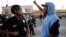 A protester confronts a Los Angles police officer during a demonstration in reaction to the acquittal of neighborhood watch volunteer George Zimmerman on July 15, 2013, in Los Angeles.