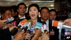 FILE - Thailand's ousted Prime Minister, Yingluck Shinawatra, talks to reporters at parliament in Bangkok, Jan. 9, 2015. 