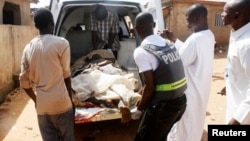 Security officials evacuate victims of a bomb attack at St. Rita's Catholic church in the Malali village in Nigeria's northern city of Kaduna, Oct. 28, 2012.