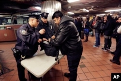 New York City Police Department Transit officers do a random bag check at the subway station under Grand Central Terminal, in New York, March 22, 2016.