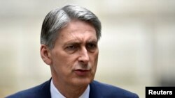 FILE - British Foreign Secretary Philip Hammond says seizing West Bank land would 'do serious damage' to Israel's international standing.