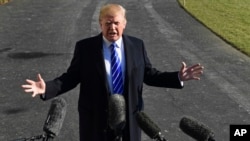 FILE - In a Saturday, Dec. 16, 2017 file photo, President Donald Trump talks with reporters as he departs from the South Lawn of the White House via Marine One in Washington, to spend the weekend at Camp David in Maryland. 