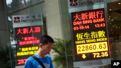 An electronic sign shows Hong Kong's benchmark Hang Seng stock index down just over 72 points by mid-morning, Friday, Oct. 3, 2014.