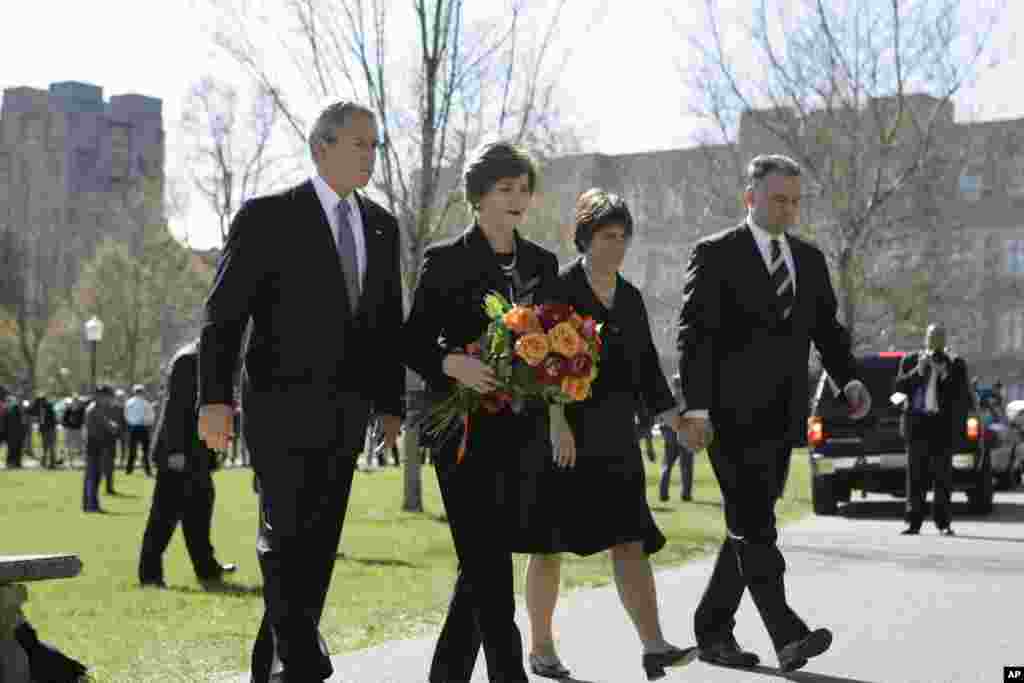 President Bush, left, first lady Laura Bush, second from left, Virginia Governor Tim Kaine, right, and his wife Anne Holton walk on the Virginia Tech campus in Blacksburg, April 17, 2007.