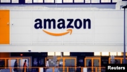 The Amazon logo is seen at the company's logistics center in Bretigny-sur-Orge, near Paris, France, Dec. 7, 2021. 