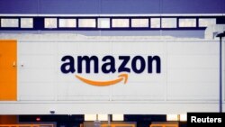 The Amazon logo is seen at the company's logistics center in Bretigny-sur-Orge, near Paris, France, Dec. 7, 2021. 