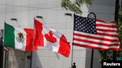 Flags of the U.S., Canada and Mexico fly next to each other in Detroit, Michigan, U.S. Aug. 29, 2018. 