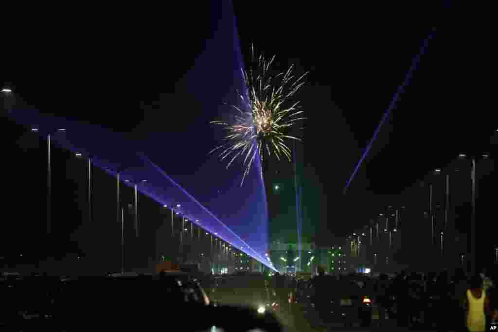 People watch fireworks explode during New Year's celebrations in Lagos, Nigeria, Jan. 1, 2019.