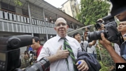 Australian journalist Ross Dunkley, co-founder of the Myanmar Times, talks to reporters after his court hearing at Kamaryut township in Yangon, June 30, 2011