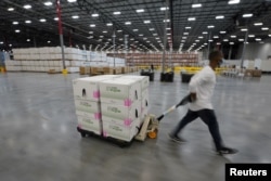 FILE - Boxes containing the Moderna COVID-19 vaccine are prepared to be shipped at the McKesson distribution center in Olive Branch, Mississippi, U.S. December 20, 2020. (Paul Sancya/Pool via REUTERS/File Photo/File Photo)