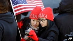 Khongorzul Battsengel, left, and Ariunbolor Davaatsogt both from Mongolia, take a picture of themselves as they wait for President Barack Obama in the 57th Presidential Inaugural Parade on Pennsylvania Ave. in Washington D.C., Jan. 21, 2013.