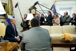 President Donald Trump speaks to reporters in the Oval Office of the White House, Feb. 9, 2018, in Washington.