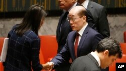 U.S. Ambassador to the United Nations Nikki Haley speaks to China's U.N. Ambassador Liu Jieyi after a vote to adopt a new sanctions resolution against North Korea during a meeting of the U.N. Security Council, Sept. 11, 2017.