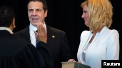 FILE - NY Governor Andrew Cuomo is sworn in during an inaugural ceremony at One World Trade Center in New York, January 1, 2015. Right is Sandra Lee, girlfriend of Governor Cuomo. 