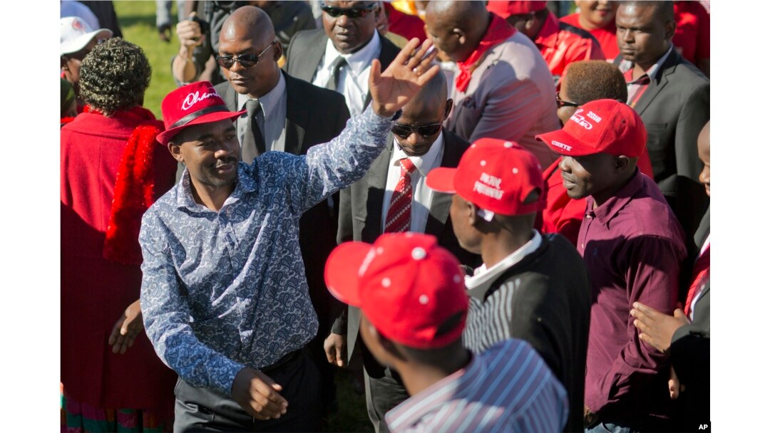 Leading opposition challenger Nelson Chamisa, left, waves at supporters as he arrives at a campaign rally in Bulawayo, Zimbabwe, July 21, 2018.