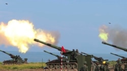 In this photo released by the Taiwan Military News Agency, Taiwanese artillery guns fire live rounds during anti-landing drills as part of the Han Guang exercises held along the Pingtung coast in Taiwan, on Thursday, Sept. 16, 2021.
