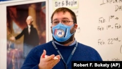 Logan Landry speaks to his class at the Bruce M. Whittier Middle School in Maine, Jan. 29, 2021. Many of the nation's teachers have given up on covering all the material normally included in their classes and instead are cutting lessons. (AP Photo/Robert F. Bukaty)