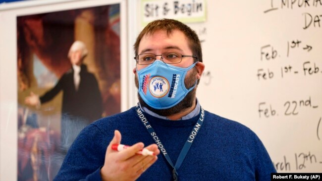 Logan Landry speaks to his class at the Bruce M. Whittier Middle School in Maine, Jan. 29, 2021. Many of the nation's teachers have given up on covering all the material normally included in their classes and instead are cutting lessons. (AP Photo/Robert F. Bukaty)