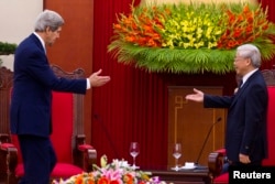 FILE - Vietnam's Communist Party General Secretary Nguyen Phu Trong greets U.S. Secretary of State John Kerry (L) in Hanoi, Dec. 16, 2013.