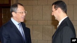 Syrian President Bashar al-Assad, right, shakes hands with Russian Foreign Minister Sergei Lavrov (2008 file photo)