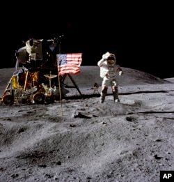 In this April 1972 photo made available by NASA, John Young salutes the U.S. flag at the Descartes landing site on the moon during the first Apollo 16 extravehicular activity.