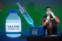 Seorang nakes bersiap menyuntik vaksin COVID-19 kepada pejabat pemerintah di Medan, Sumatera Utara, Kamis, 14 Januari 2021.