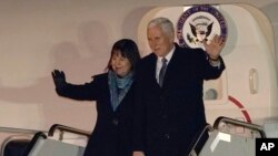 U.S. Vice President Mike Pence and his wife Karen walk upon their arrival at Yokota Air Base on the outskirts of Tokyo, Tuesday, Feb. 6, 2018. Vice President Pence's six-day swing through Asia will include a stop at the Winter Olympics in South Korea. (AP Photo/Shizuo Kambayashi, Pool)