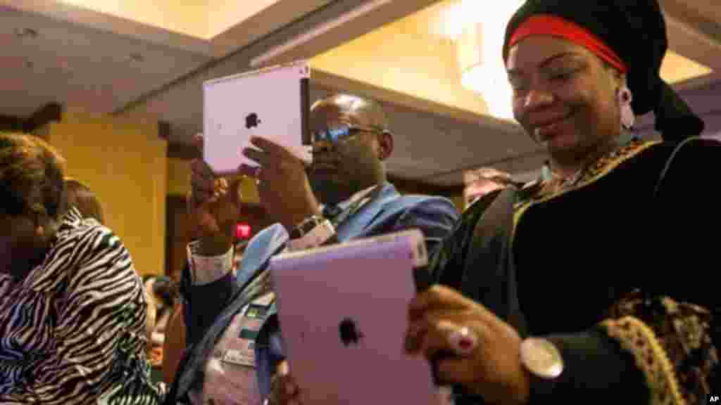 Misan Ukubeyinje, commissioner of the Ministry of Agriculture and Natural Resources for the Delta State of Nigeria, left, and Baraka Sani, commissioner of the Kano State Ministry of Agriculture and Natural Resources in Nigeria, record video on iPads as fo