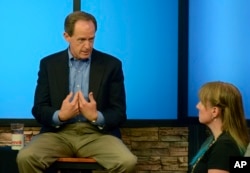 Pennsylvania's U.S. Sen. Pat Toomey answers a question from Nancy Rohrbaugh, of Dillsburg, Pa., right, during an hourlong question-and-answer session in the studios of WHTM-TV, July 5, 2017 in Harrisburg, Pa. Toomey took questions in front of a live audience in public for the first time this year.
