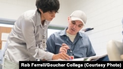 Goucher professor Citlali Miranda-Aldaco works with Goucher College student Shawn Vankirk, who is enrolled with Goucher College through the Goucher Prison Education Partnership and takes his courses at the Maryland Correctional Institution Jessup (MCIJ). 