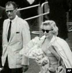 Marilyn Monroe arrives in London, with husband Arthur Miller, to film "The Prince and the Showgirl" in 1956.