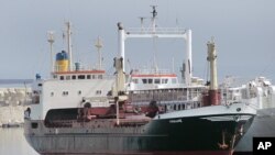 FILE - A ship believed to be carrying three containers of weapons is docked at a Lebanese navy base, in Beirut, Lebanon, April 28, 2012. The ship came from Libya via Egypt, and then to the port of the Lebanese north city of Tripoli on its way to Syria, according to Lebanon's state-run National News Agency. 