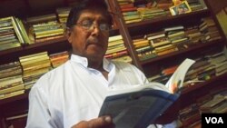 Mandalay's sole Muslim candidate, Khin Maung Thein, is seen reading a book in his home. (Photo - S. Lewis/VOA)