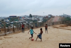 Rohingya refugee children play football in the Balikhali camp in Cox's Bazar, Bangladesh, Aug. 23, 2018.