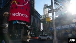 An advertisement for "RedNote," a Chinese social media app, is seen as people walk by the Nasdaq headquarters in Times Square, Jan. 27, 2025 in New York City. 