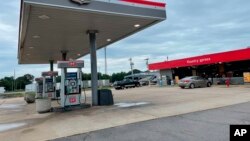 A car is parked outside the Kountry Xpress in Mulberry, Ark. Three law enforcement officers have been suspended after a video posted on social media showed a South Carolina man being held down on the ground and beaten by police.