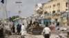 Police and military officials comb the scene of an al-Qaida-linked al-Shabab group militant attack, in Mogadishu, Aug. 21, 2022.