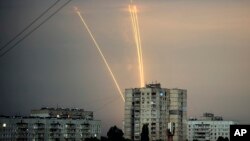 Russian rockets launched against Ukraine from Russia's Belgorod region are seen at dawn in Kharkiv, Ukraine, Aug. 15, 2022. 