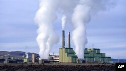 FILE - Steam billows from a coal-fired power plant in Craig, Colo., Nov. 18, 2021.