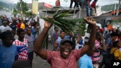 A demonstrator shouts during a protest to demand Haitian Prime Minister Ariel Henry step down and call for better quality of life, in Port-au-Prince, Haiti, Aug. 22, 2022. 