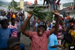Demonstrators shout during a protest in Port-au-Prince, Haiti, Aug. 22, 2022.