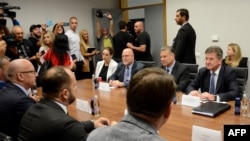 FILE - Gabriel Escobar, U.S. deputy assistant secretary of state for the Western Balkans, second right, and others meet with Serbian political leaders in North Mitrovica, Kosovo, Aug. 25, 2022.