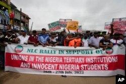 FILE - Nigeria Labour union protest in solidarity with the Academic Staff Union of Universities, on the street in Lagos, Nigeria, on July 26, 2022.