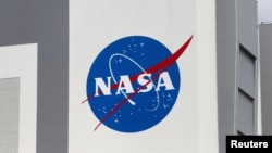 FILE - The NASA logo is seen at Kennedy Space Center ahead of the NASA/SpaceX launch of a commercial crew mission to the International Space Station in Cape Canaveral, Florida, April 16, 2021.