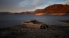 FILE - A formerly sunken boat sits high and dry along the shoreline of Lake Mead at the Lake Mead National Recreation Area, on May 10, 2022, near Boulder City, Nevada. (AP Photo/John Locher, File)