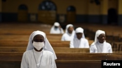 FILE - Nuns attend the Last Supper Mass in a cathedral in Ouagadougou, Burkina Faso, April 9, 2020. An American nun, who was abducted by jihadists in northern Burkina Faso in April 2022, has been released.